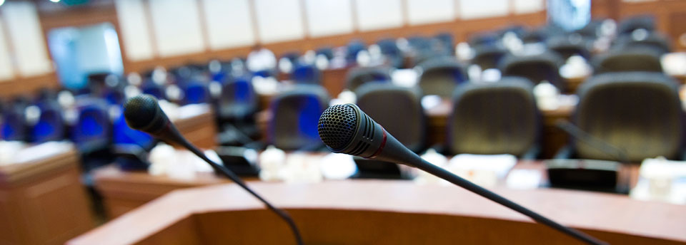 Image of council chambers with microphones